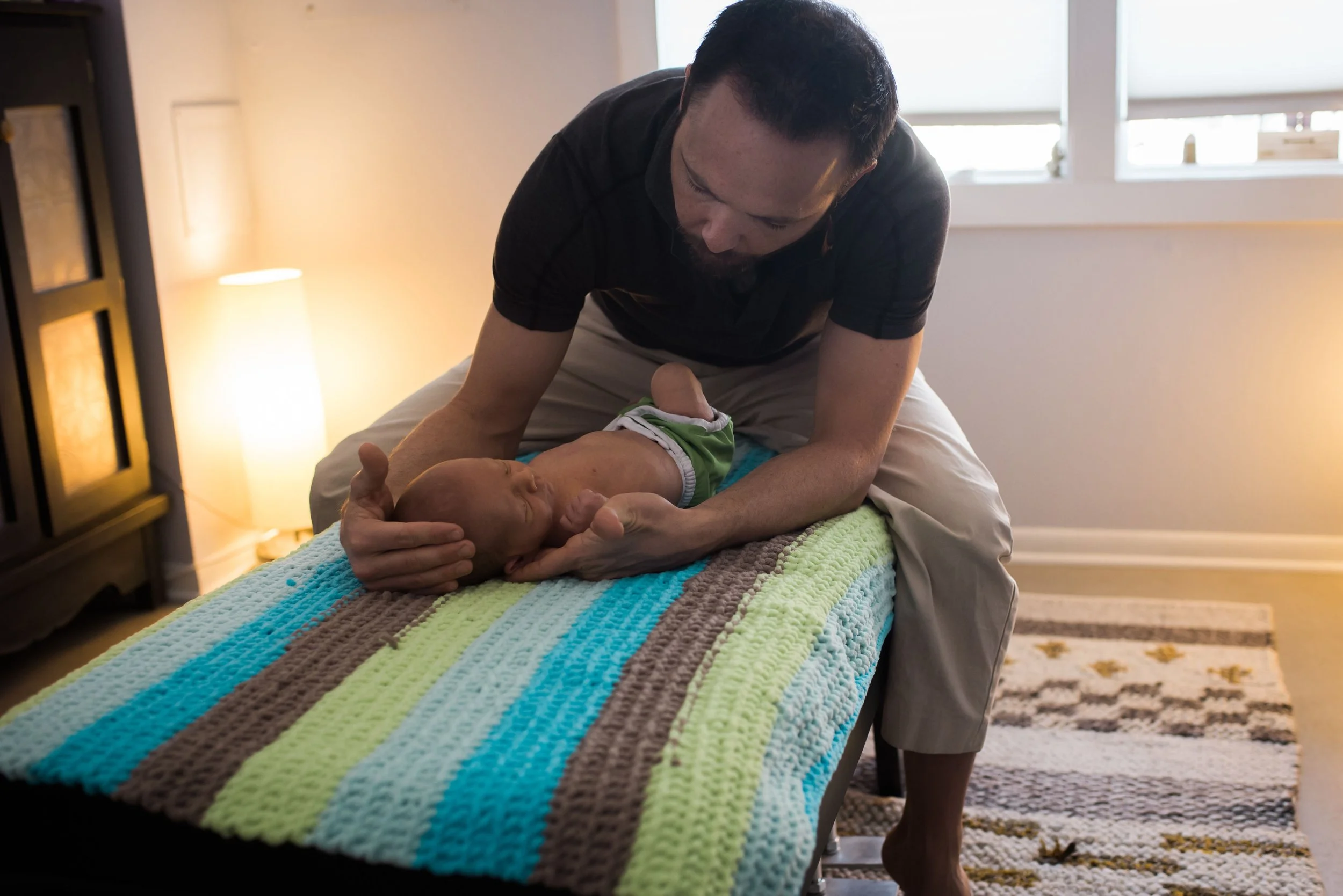 Dr. Dylan adjusting newborn
